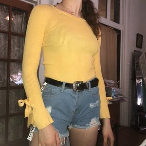 Yellow long sleeved knit shirt with flare wrists!